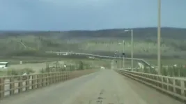 BridgeoverYukonriverwithAlaskaPipelineinbackground.webp
